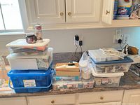 Overall view of stacked storage boxes and sewing supplies on counter