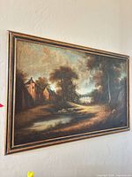 Frontal view of framed landscape painting on wall