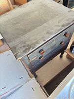 Overall view of black painted solid wood nightstand showing top surface and drawer fronts