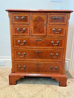 Front view of dresser showing drawer layout, central cupboard, hardware, and base
