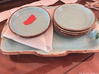 Serving tray with stacked small plates showing color, glaze, and quantity