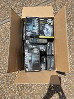 Box with several Uniden Accessory boxes, loose handset visible