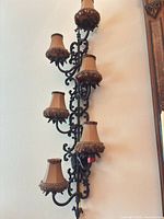 Full view of vertical six-light wall sconce mounted on wall