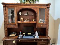 Front view showing full hutch desk, glass doors, shelves, desktop and drawers