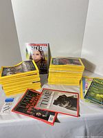 Overall view showing two tall stacks of National Geographic, Vanity Fair issue, TIME covers and smaller stacks