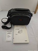 Carrying bag with strap, instruction manual and auction tag