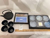 Group shot showing teapot, four cups, boxed sushi set and boxed six-piece bowl set