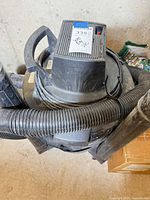 Top view of Craftsman wet/dry vacuum showing handle, motor housing, hose connection and dust
