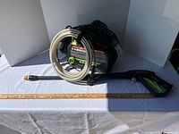 Full view of pressure washer with hose, wand and power cord