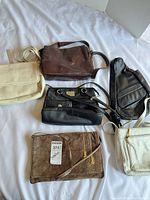 Overall view of six assorted bags on bed