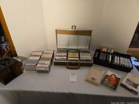 Overall view of metal case filled with cassettes, plastic tray with tapes, carousel, three boxed sets