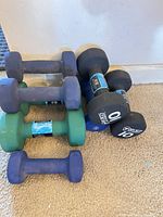 Stacked neoprene and rubber hex dumbbells showing weight markings