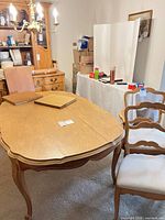 Dining table with two chairs visible, showing style and finish