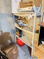 Full view of plastic shelving unit with loose shelving parts