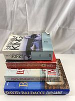 Stack of four novels showing spines and formats