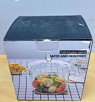 Front of retail box showing clear glass pot with vegetables