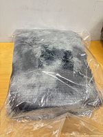 Rug folded inside original plastic packaging