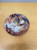 Front view of porcelain plate showing full illustration and gold rim
