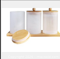 Three glass jars with bamboo lids on bamboo tray; one lid removed for view