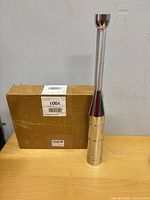 Assembled clubbell standing beside original box