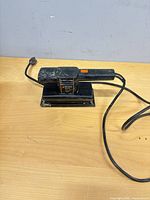 Overall view of Black & Decker finishing sander with power cord on work surface