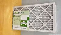 Front view of shrink-wrapped Booglian air filter showing pleated media and label