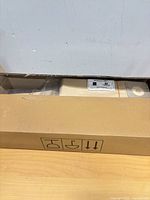 Cardboard shipping box partially opened showing sealed packs inside
