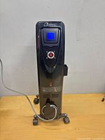 Front view showing digital display, control panel, wheels and cord