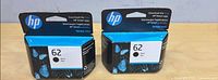 Front view of both sealed HP 62 black ink cartridges