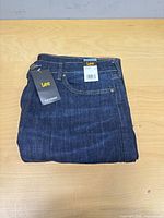 Folded Lee jeans with tags visible