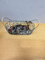 Full view of wire basket containing assorted jewelry