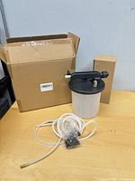 Kit components laid out: 3 L reservoir with lid, hose, fittings, boxes