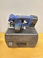Circular saw resting on carrying case, full view