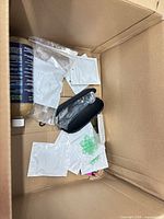 Box with large bottle, sealed pouches, zip case, green pieces