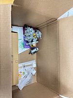 Overall view of box with carburetor, motor, packages and inserts visible