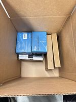 Top view of box showing AQQA heater boxes, slim brown box, other packages