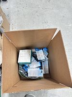Top view of open box showing multiple retail-packaged items