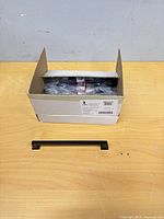 Closed box with one cabinet pull displayed in front