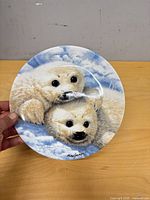 Front view of the plate showing seal artwork and artist signature