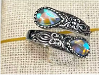 Close-up of ring showing opal stones and filigree design