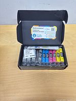 Open box displaying seven individually sealed Smart Ink 564XL cartridges