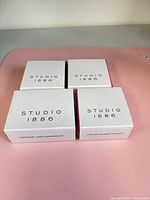 Front view of four Studio 1886 Avon jewelry boxes