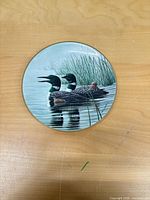 Front view of plate showing loon artwork and gold rim
