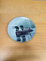 Front view showing loon artwork and gold rim
