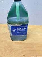 Front view of jug showing label and remaining liquid