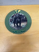 Front view of decorative plate showing panther image and border