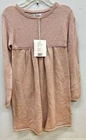 Front view of full dress on hanger showing design and color