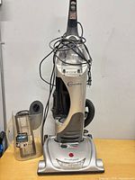 Full view of Hoover WindTunnel upright vacuum showing body, handle, cord, dust canister detached