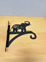 Single bracket unwrapped showing elephant design and hook