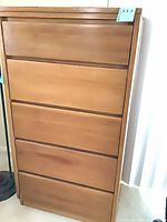 Front view of five-drawer light brown veneer dresser